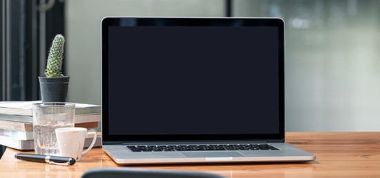 Laptop resting on a wooden desk